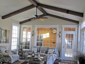 vaulted ceiling with dark wood beams